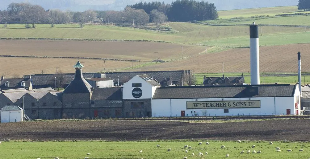 White distillery buidling of Ardmore surrounded by fields in the countryside
