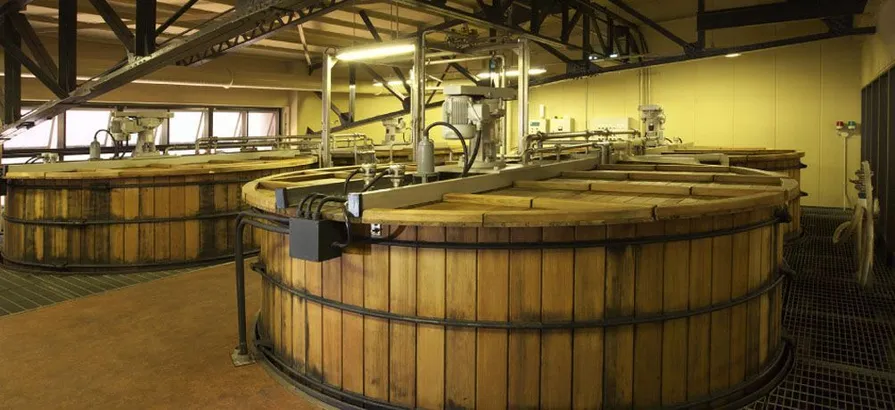 An interior view of Suntory Yamazaki's distillery with four wooden washbacks