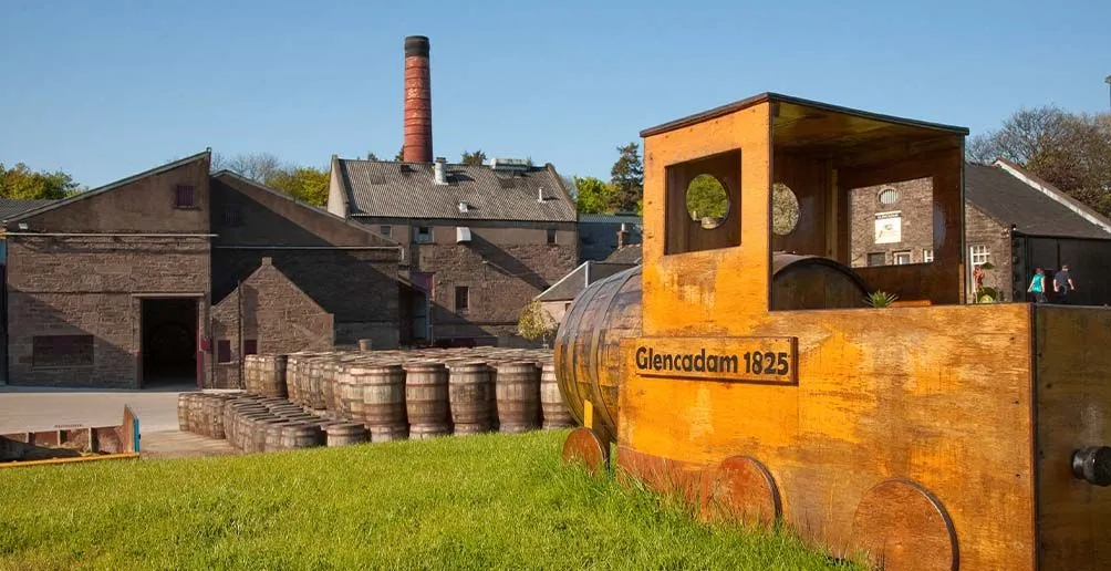 Overlooking Glencadam's warehouse with its yard full of casks from behind a wooden model of a train