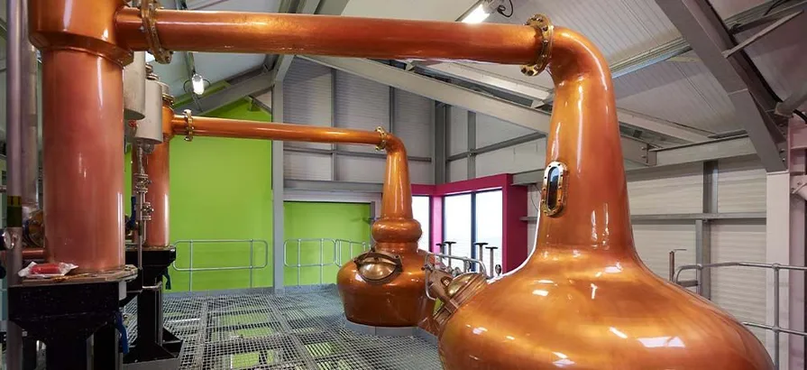 Close view on two copper pot still in GlenWyvis still house