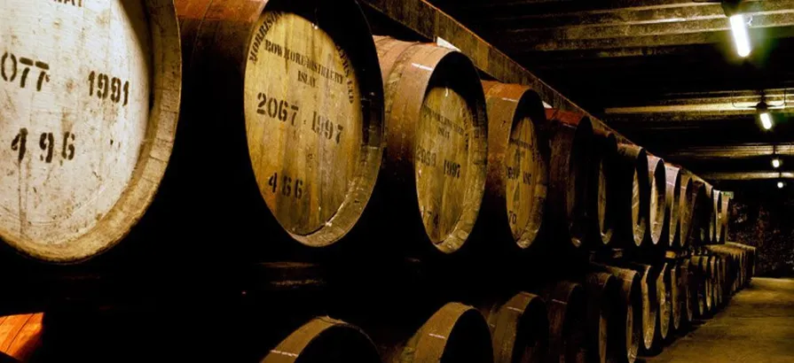 Old Bowmore casks stored in two rows on top of each other in the dunnage warehouse