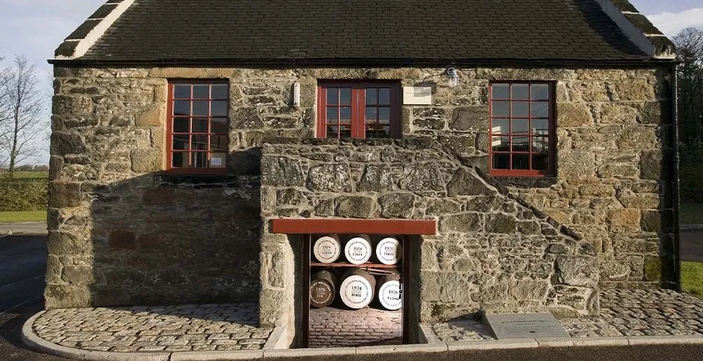 Casks stacked in Glenburgie's warehouse viewed from the outside through the basement door.