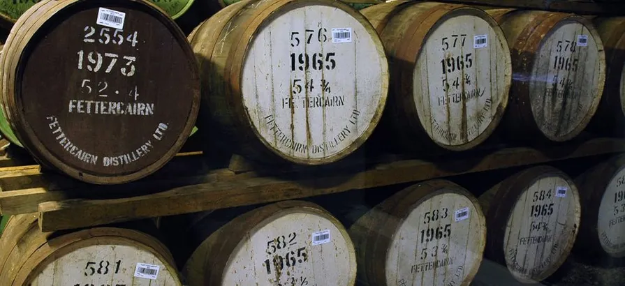 Close view on some numbered barrels with the Fettercairn logo on their lids stored in the warehouse