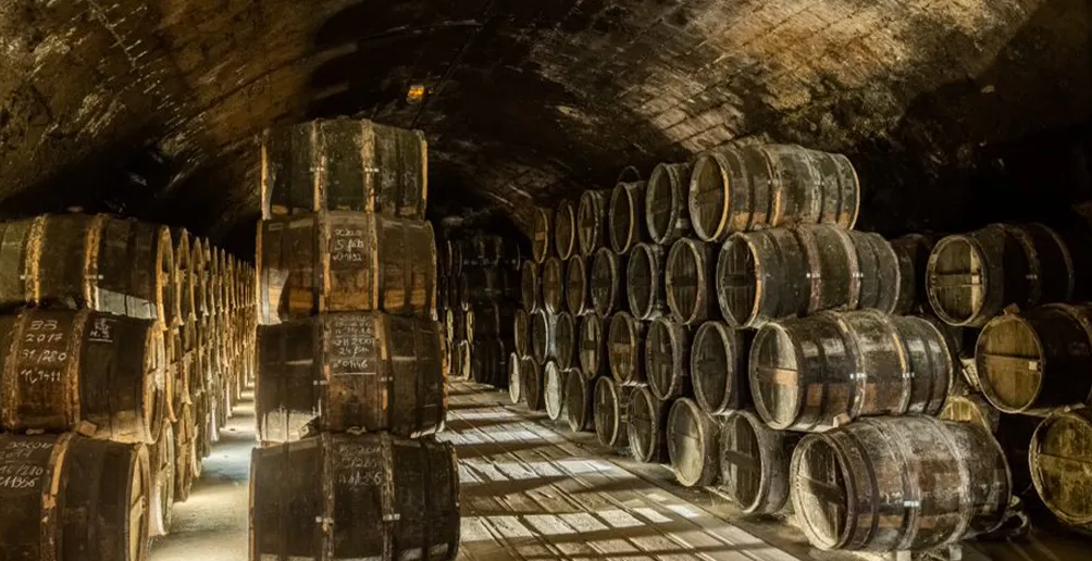 Rows of barrels stacked on top of each other inside Otard warehouse