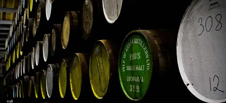 Rows of casks stacked on top of each other with numbered lids in different colors