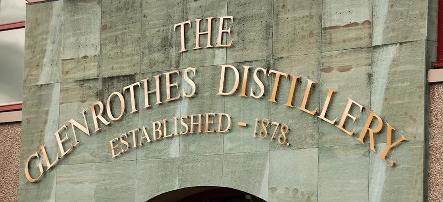 The gold logo of Glenrothes distillery over the main entrance