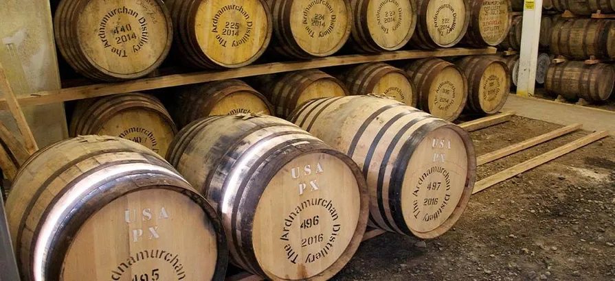 Casks stacked in shelves and on the floor of Arnamurchan's warehouse