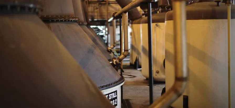 Close view on a row of pot stills inside of Appleton Estate factory