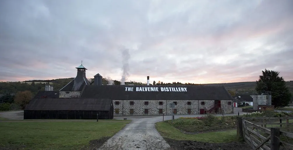 Steam coiling from Balvenie distillery building on a cloudy day