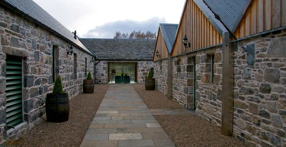 Path to Ballindalloch's reception room between two rows of dunnage warehouses made of stone
