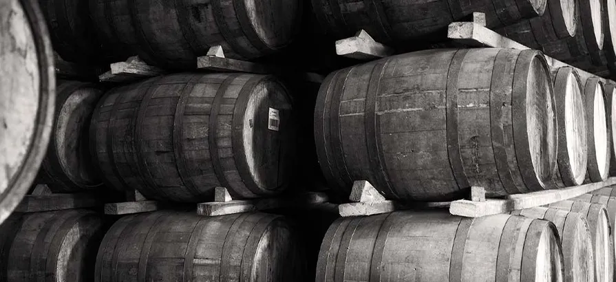 Black and white photo with close view on casks stacked in Glenburgie's warehouse