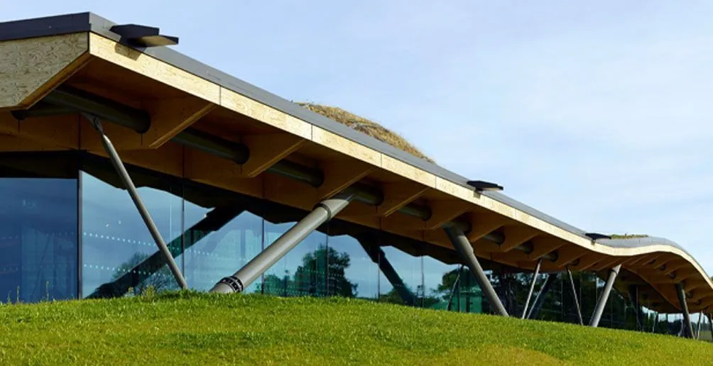 Exterior view of Macallan distillery's building with its extraordinary curvy roof and see-through walls located on a green hill