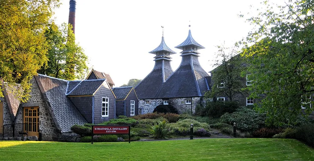 Distillery building made out of bricks with its extraordinary pagoda style roof surrounded by nature