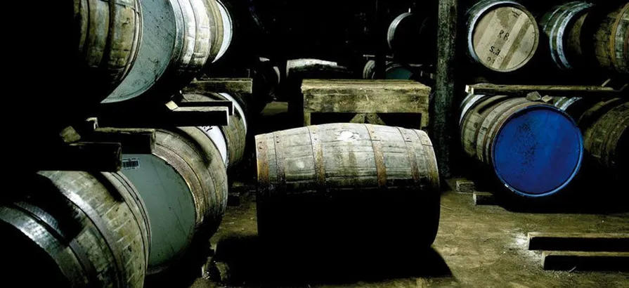 Casks stacks in shelves with blue and white lids in Bunnahabhain warehouse