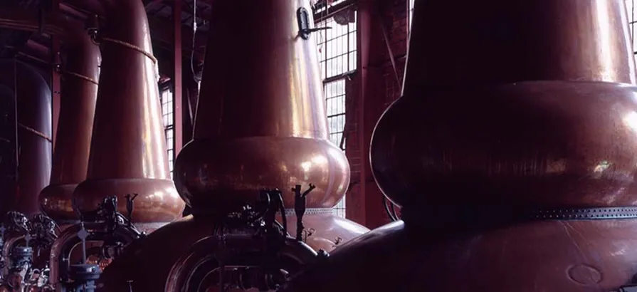 Row of copper pot stills in Miyagikyo's still house