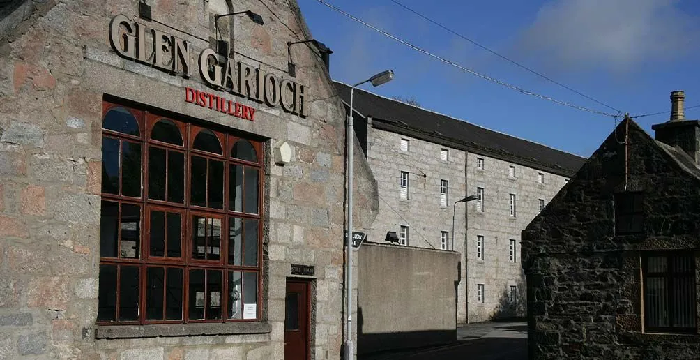 Glen Garioch's distillery buildings made of stone with its name attached on the wall