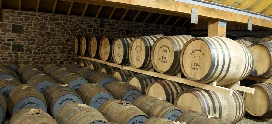 Casks stacked on shelves and on the floor in Ballindalloch's warehouse with their number and date of maturation painted on the lids