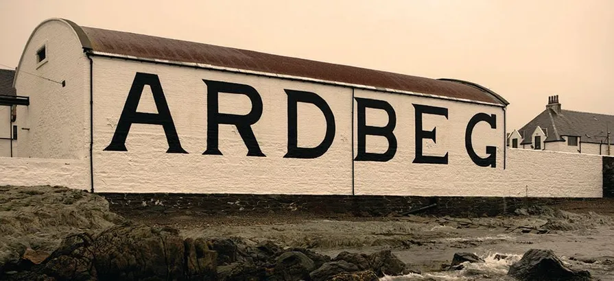 A side view of a building in Ardberg distillery with its name painted on the wall