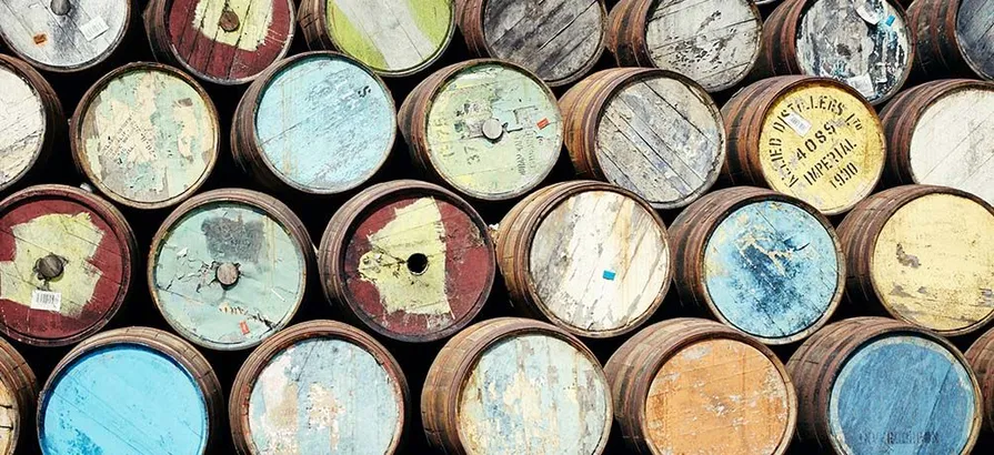 Casks with lids in different colors stacked on top of each other at Craigellachie distillery