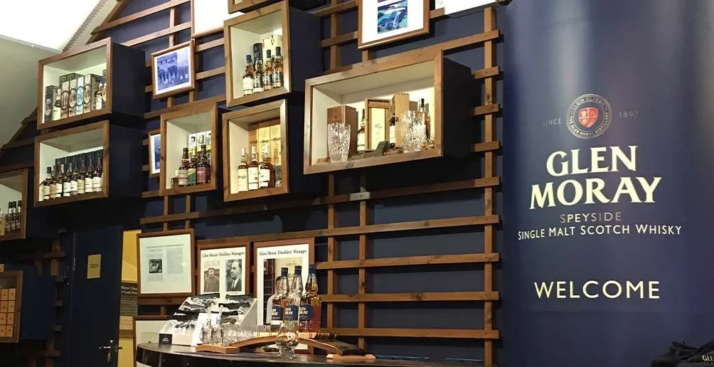 Wide range of products exhibited on shelves inside of Glen Moray's visitor center