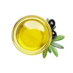 Small bowl of olive oil surrounded by olive