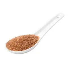 A spoon loaded with brown sugar